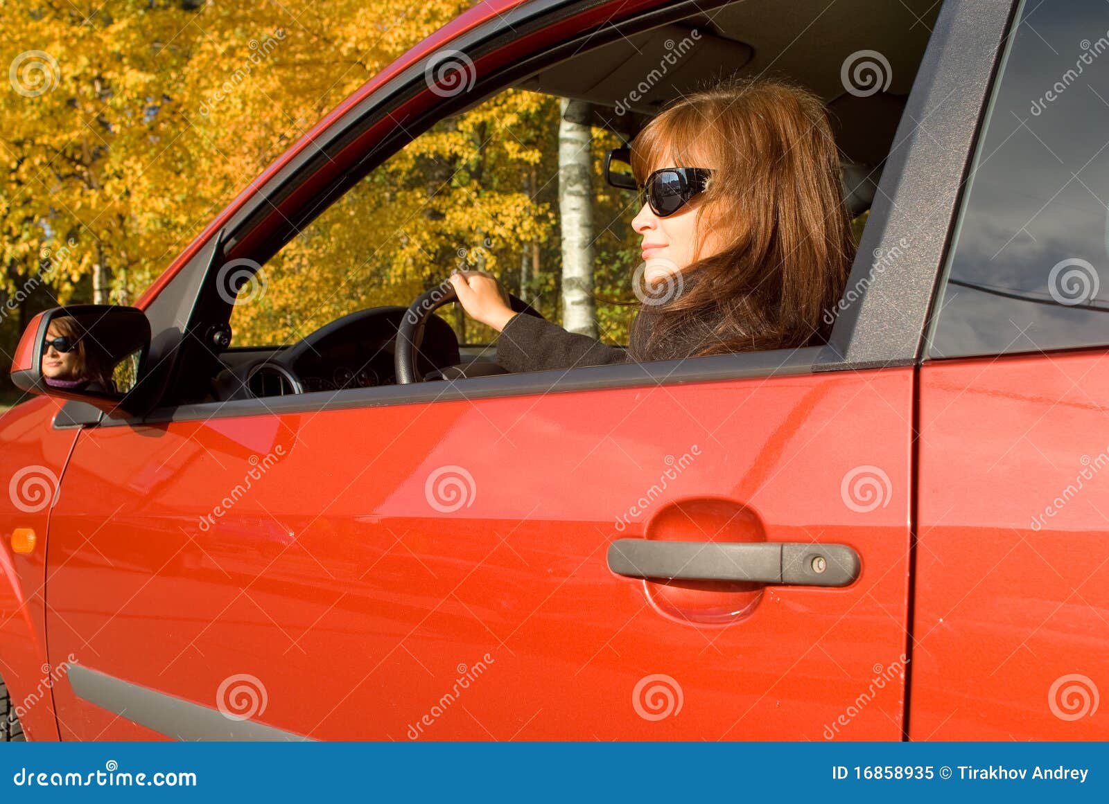 the girl with sunglass in the red car