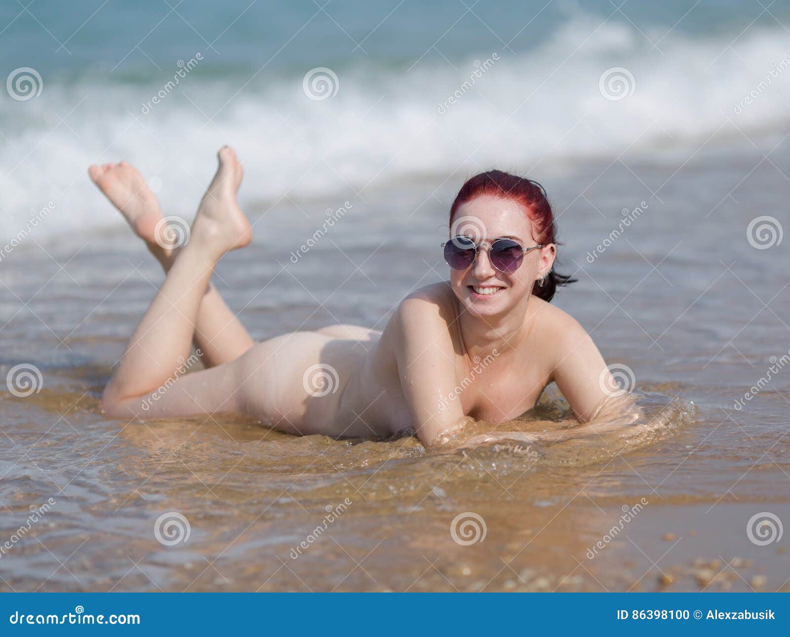 Girl in Sunglasses Lays on Sand Looks at Camera Smiling Stock Photo - Image  of hair, lifestyle: 86398100