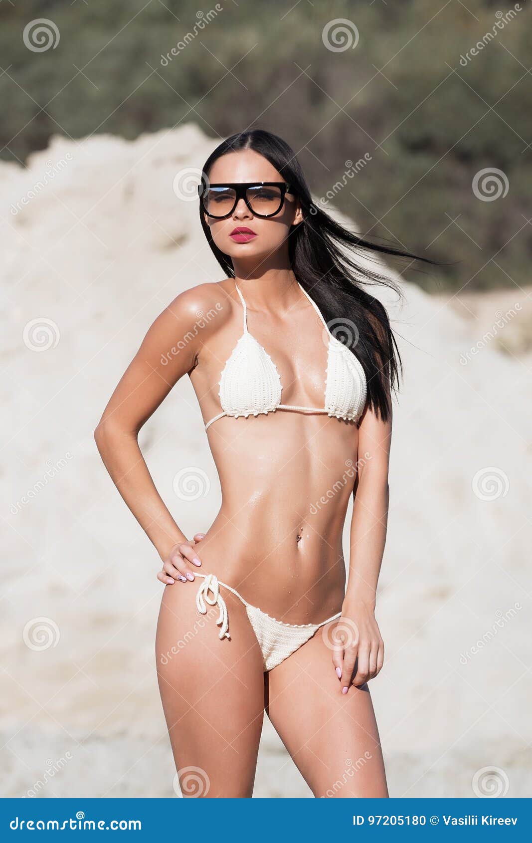 Photo about Girl in a swimsuit on the beach. 