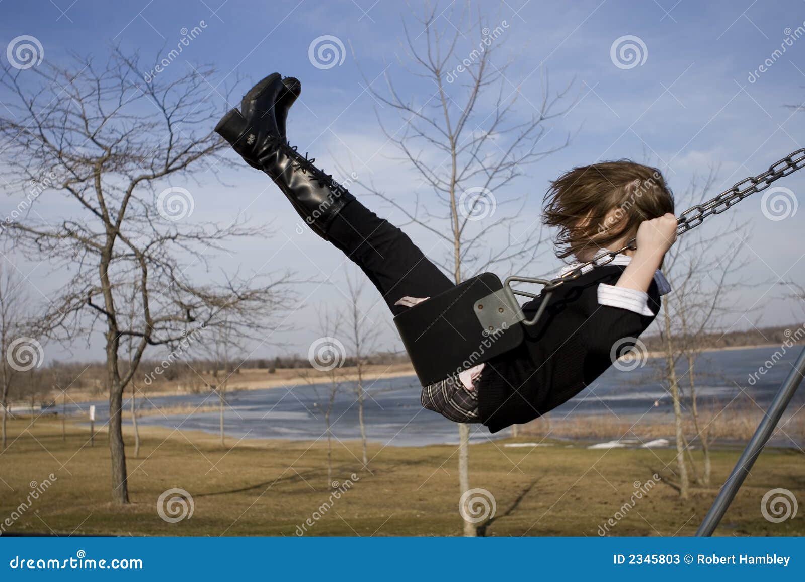 A young girl uses outdoor exercise equipment to exercise in a park on a  sunny day Stock Photo - Alamy