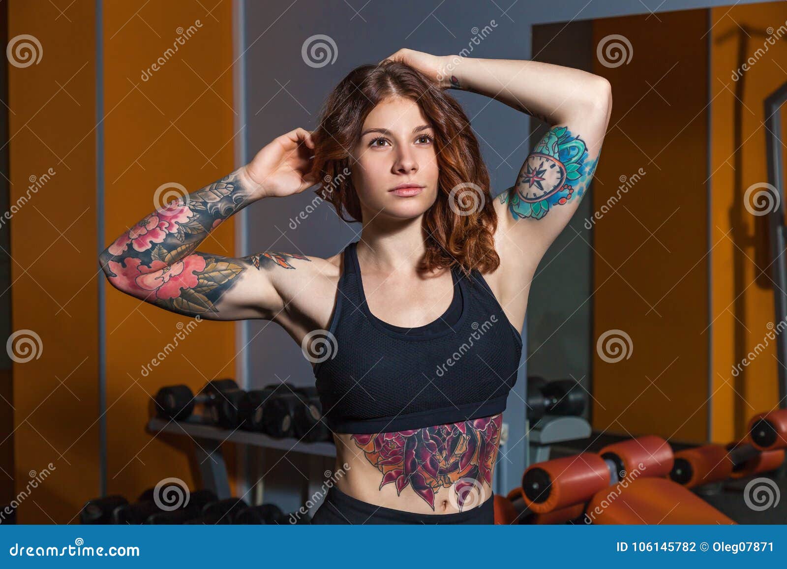 Premium Photo | A woman with tattoos on her back is shown with a large  window in the background.