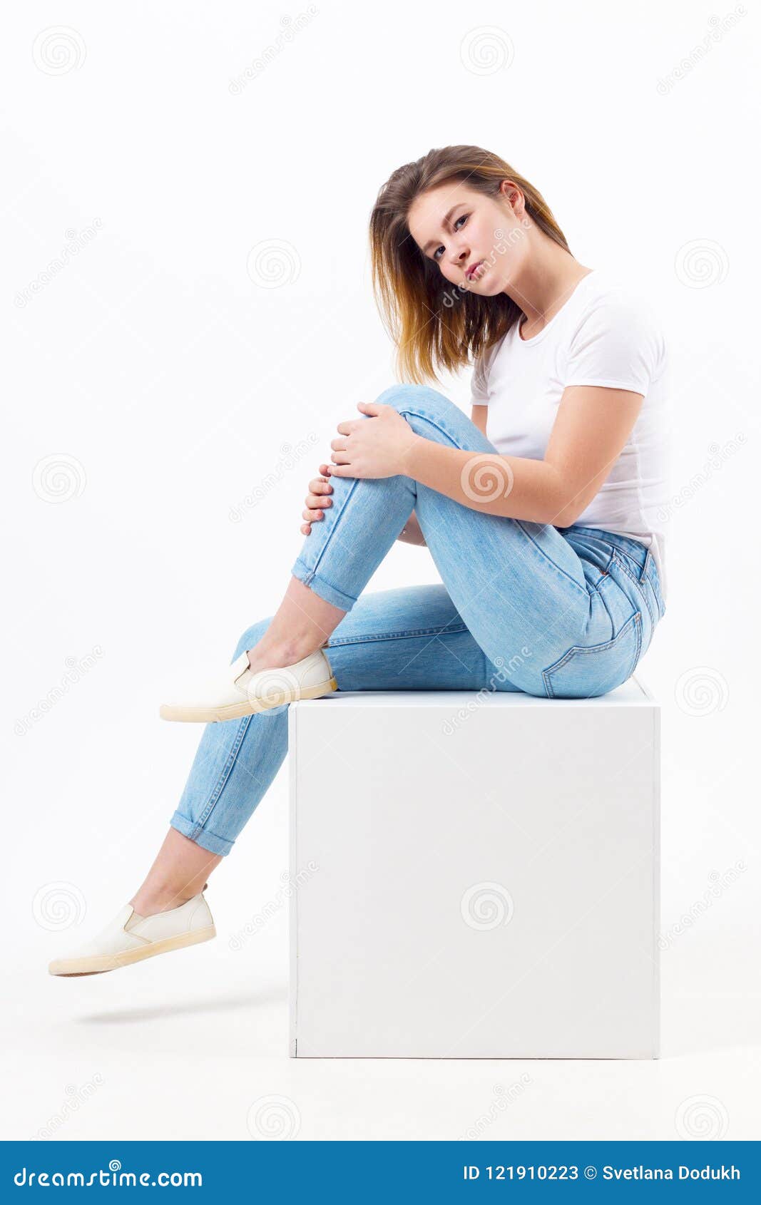 Girl Teenager in Blue Jeans Sits on Cube in White Studio Stock Image ...