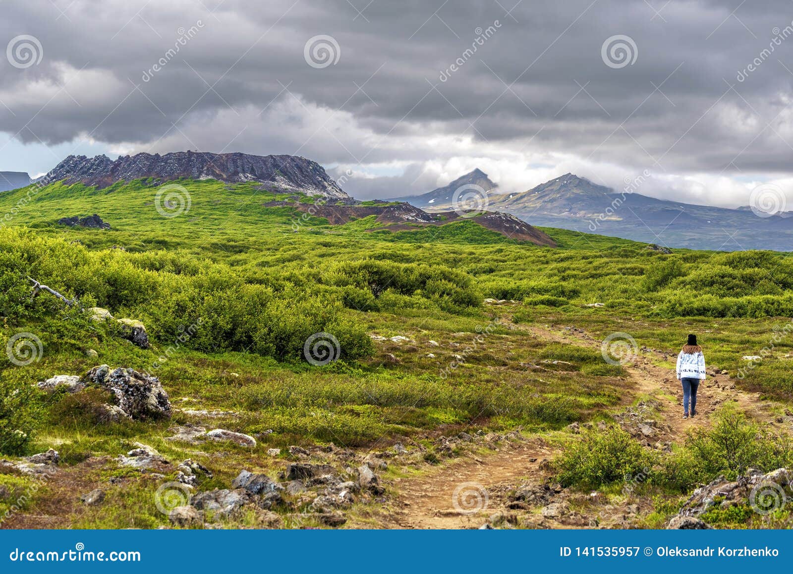 girl teenager on the walk pass to eldborg volcano crater in vesturland region of iceland