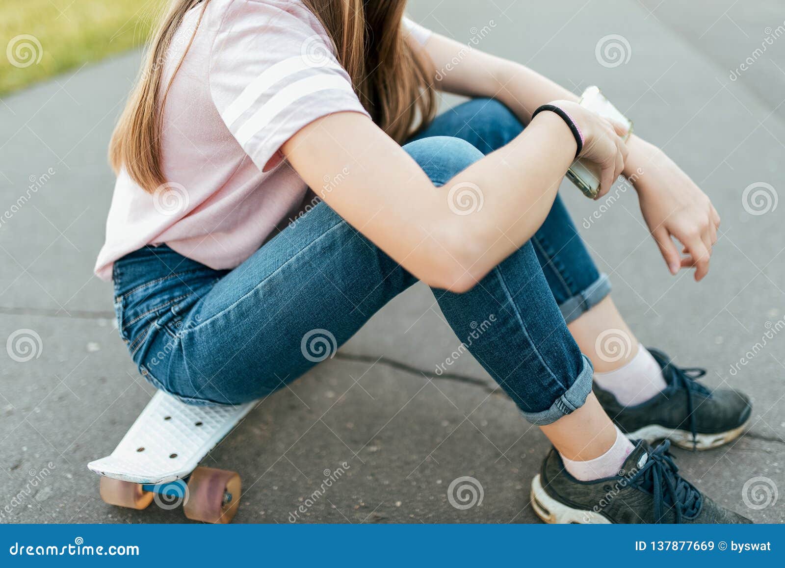 Girl Teenager 7-14 Years Old, Sitting on Skateboard in a City Park in ...