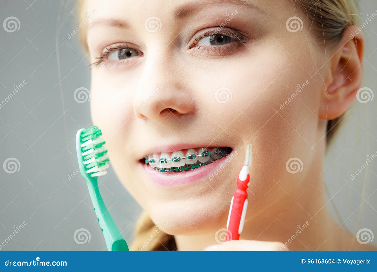 Girl With Teeth Braces Using Interdental And Traditional Brush St