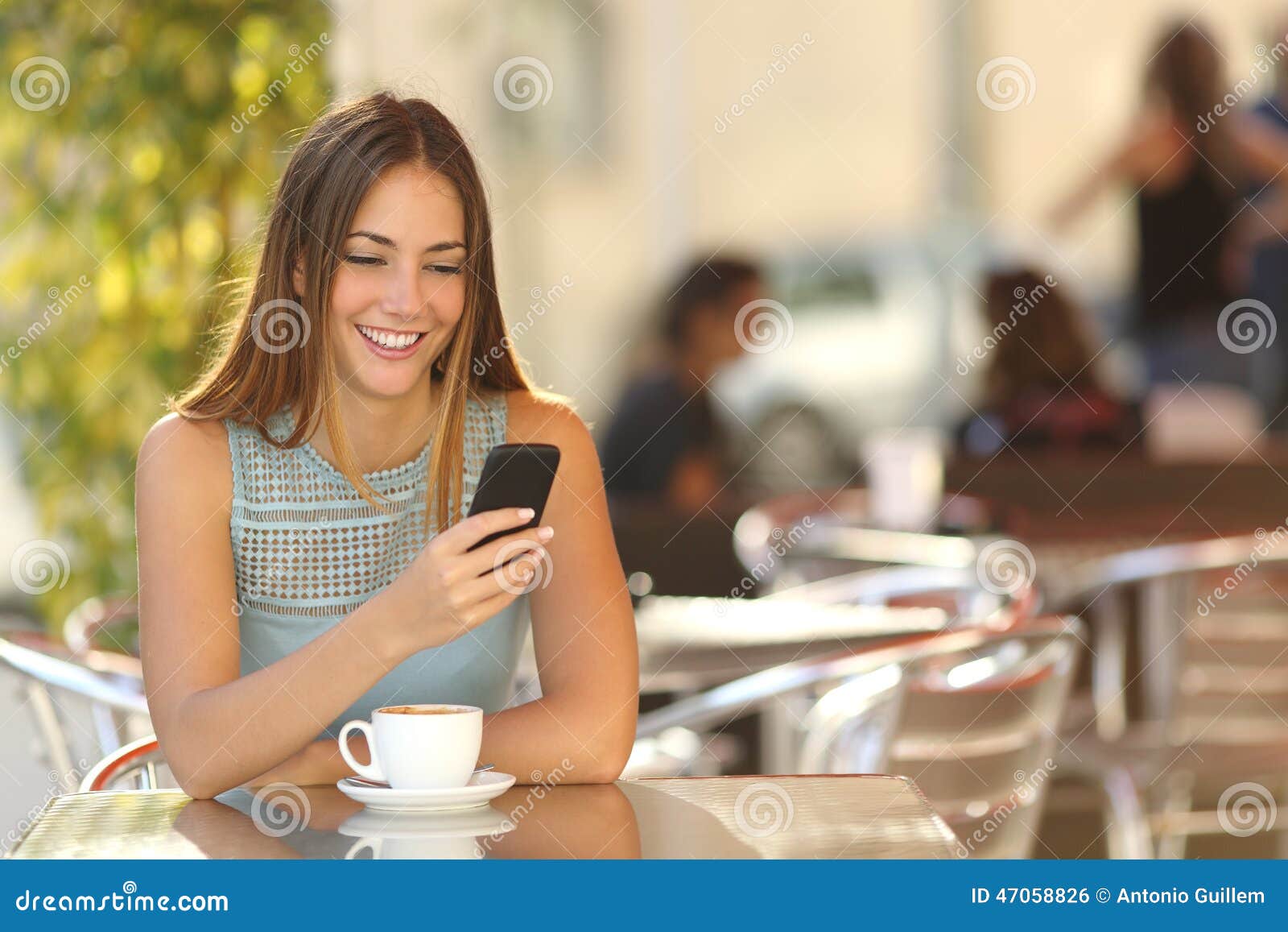 girl texting on the phone in a restaurant