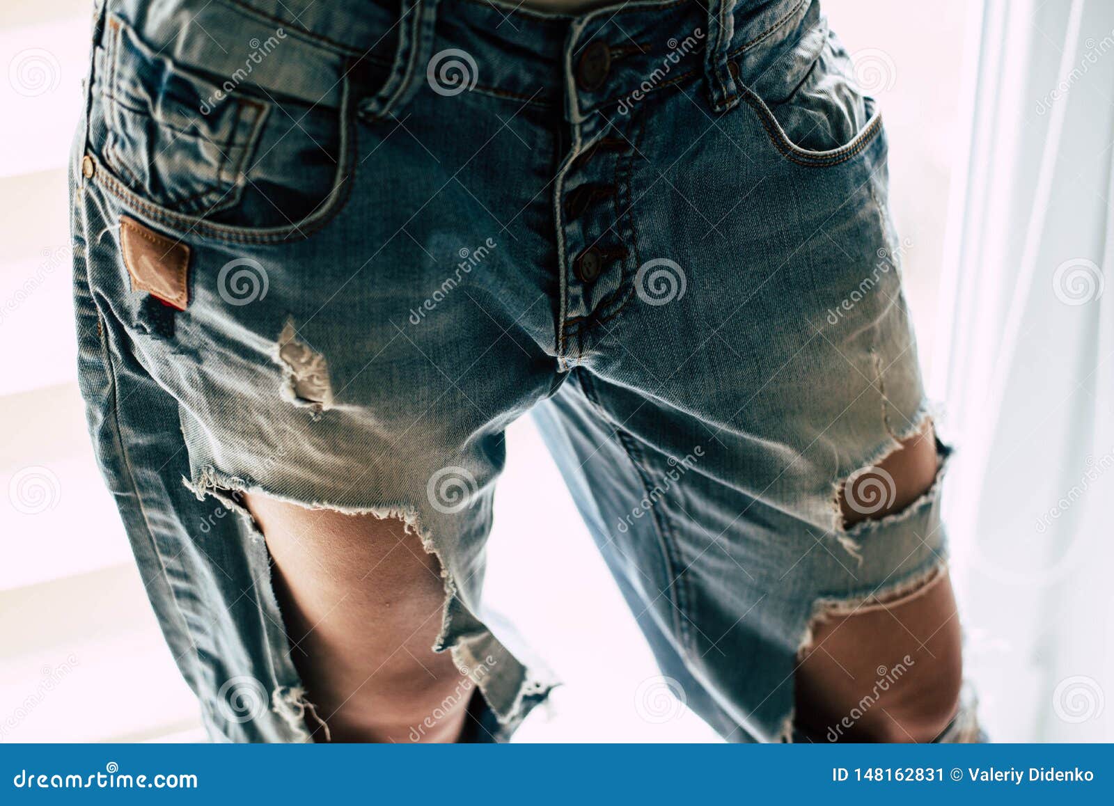 Torn jeans on the girl stock image. Image of glamour - 148162831