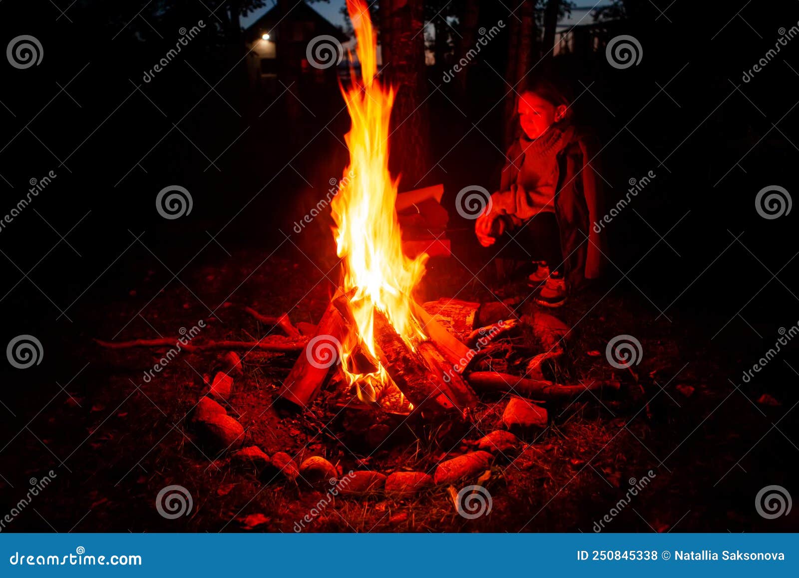 Girl Tourist, Warming Herself by the Fire at Night in a Tourist Camp ...