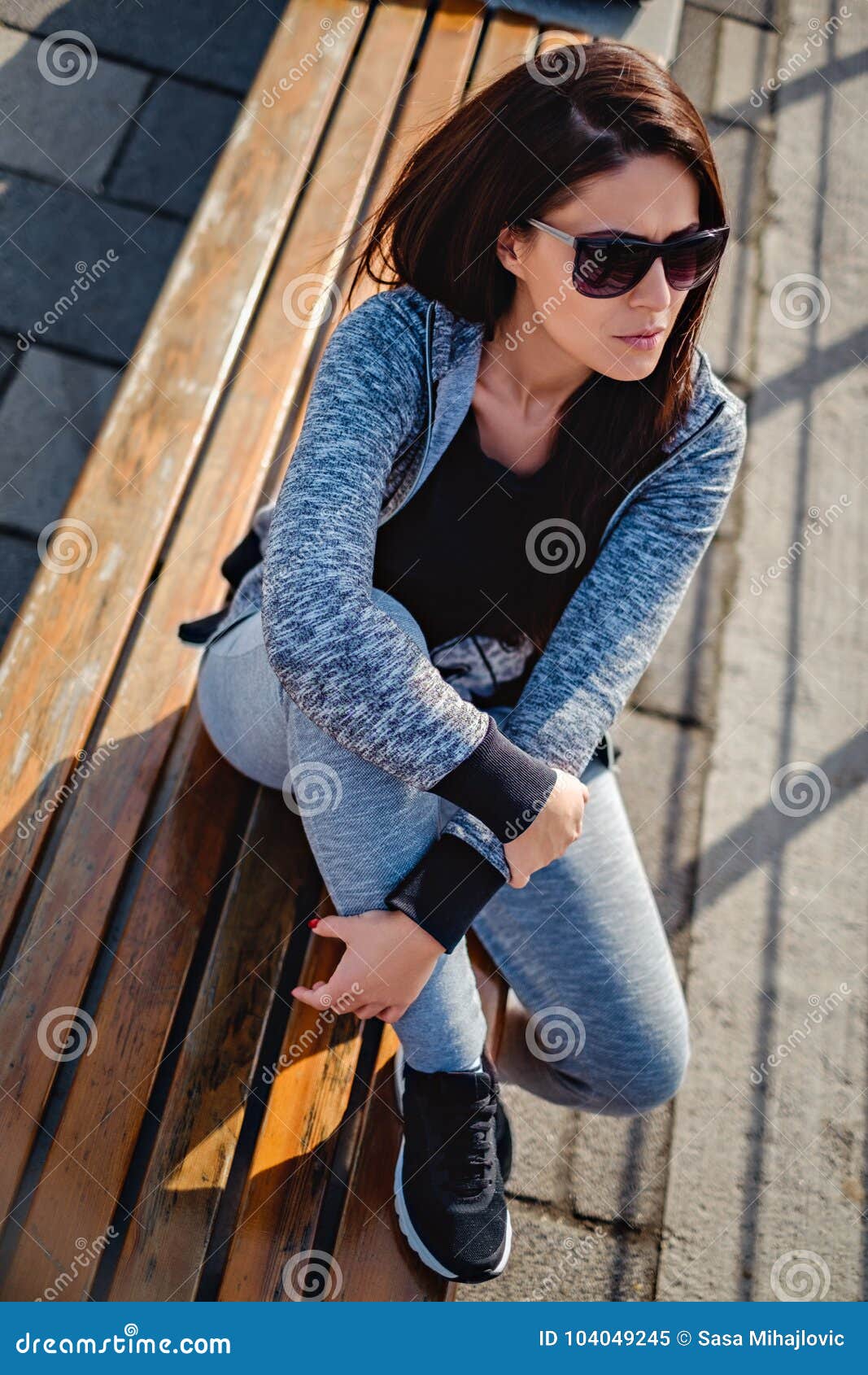 Girl in a Tracksuit Sitting on the Bench Outside Stock Image - Image of ...