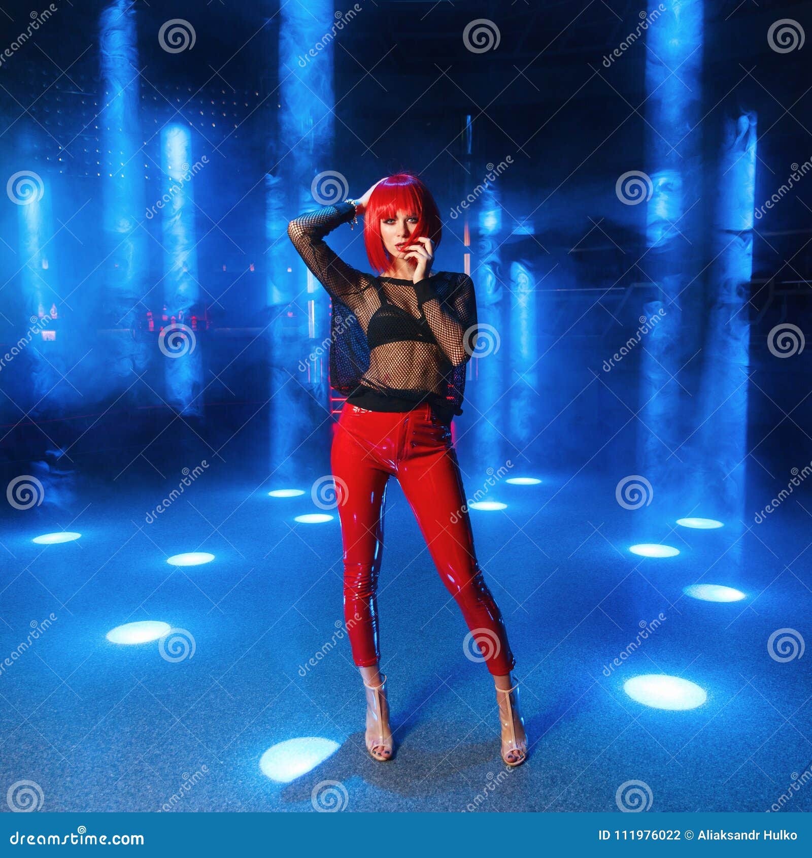 The Girl with Red Hair in the Spotlights at Night Club Stock Photo ...