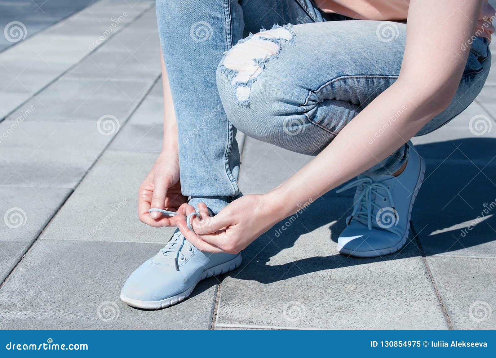 The Girl is Tying Shoelaces on Sneakers. Stock Image - Image of lace ...
