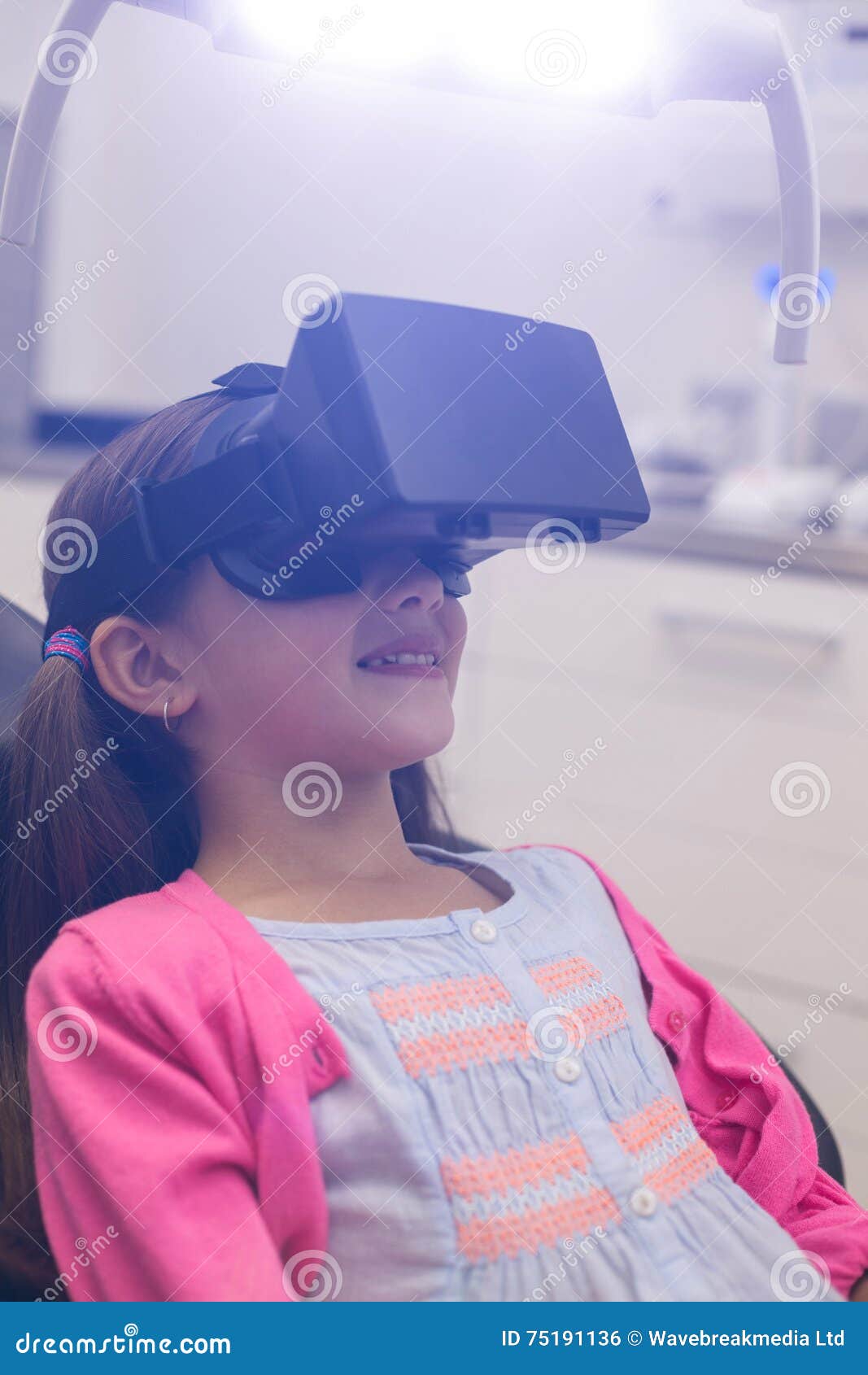 Girl Using Virtual Reality Headset during a Dental Visit Stock Photo