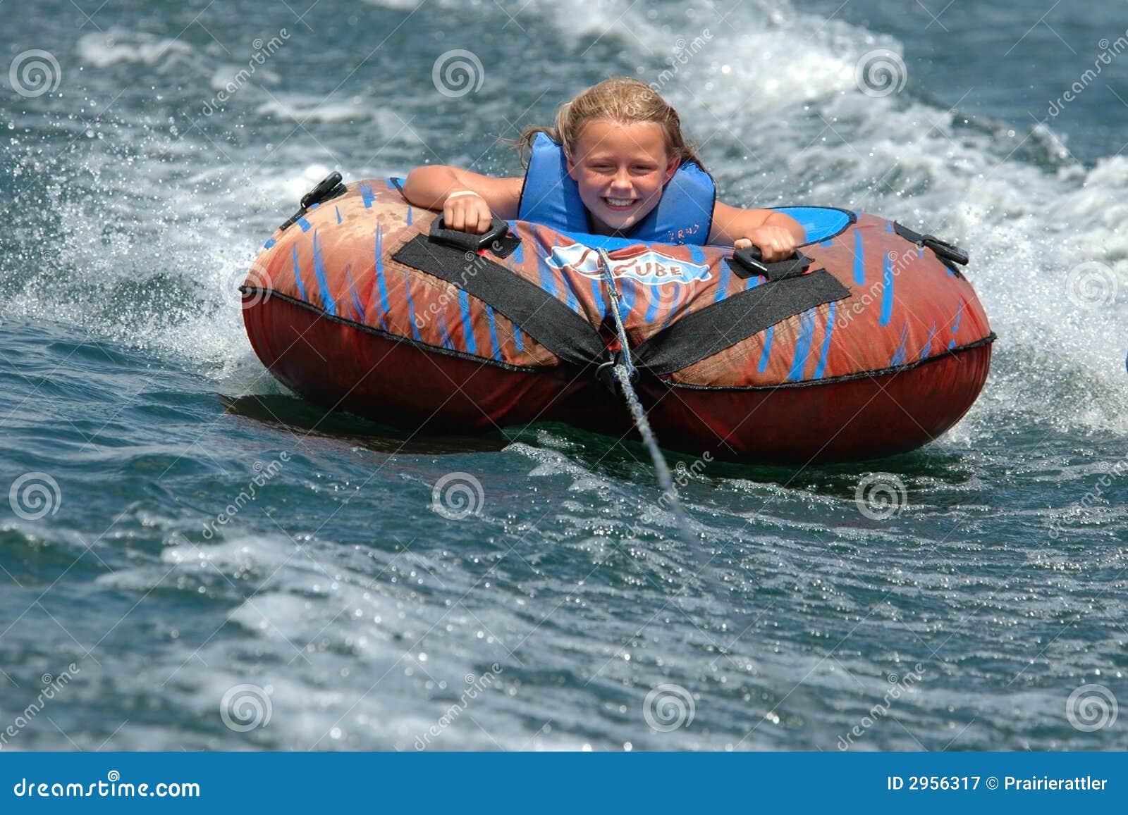girl water tubing with a smile