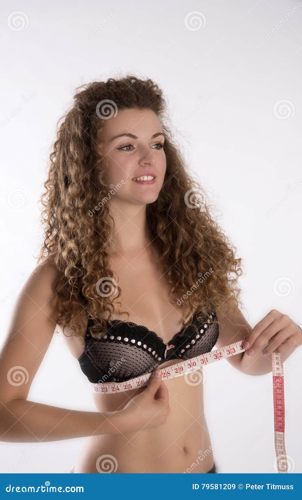 Young African American Woman Wearing Lingerie Using Tape Measure