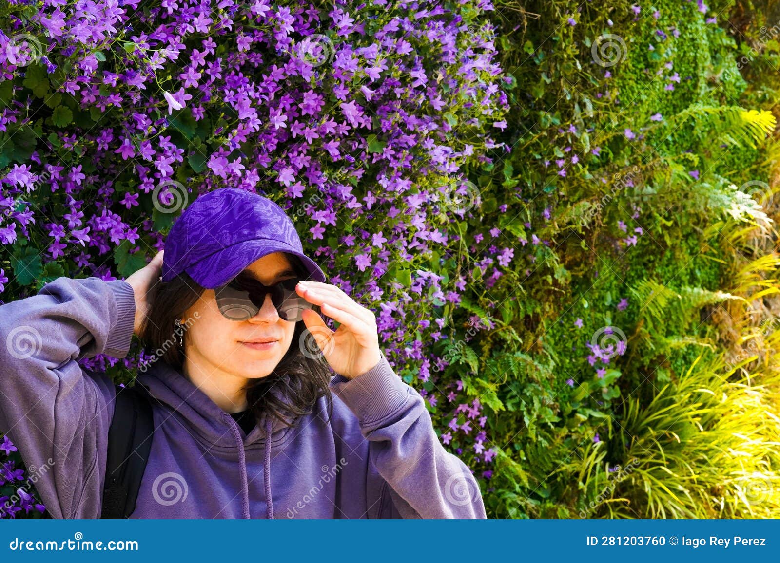 Girl Wearing Purple Clothes on a Purple Flowers Wall Stock Photo ...