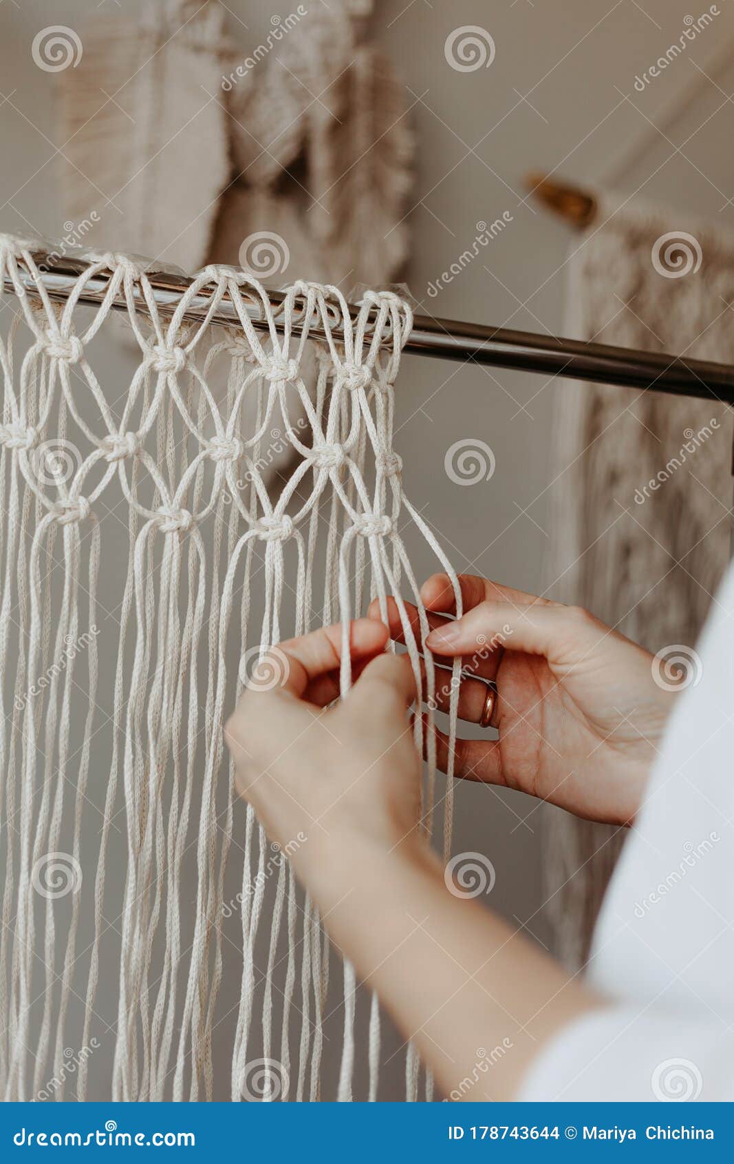 the process of weaving macrame. hands weave macrame decor