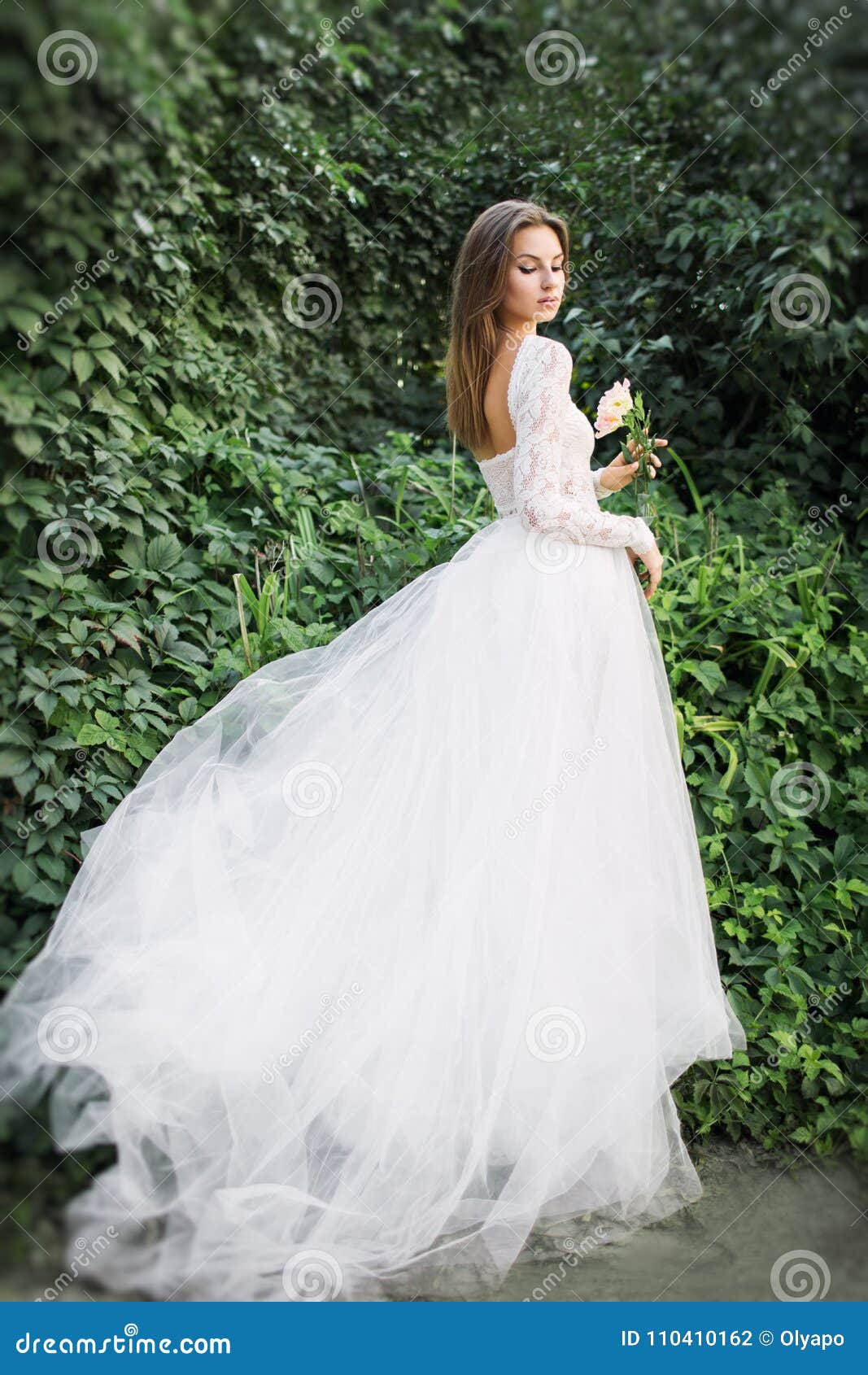 Free Photo | Bride with a bridal hairstyle wearing wedding dress holding a  flower bouquet