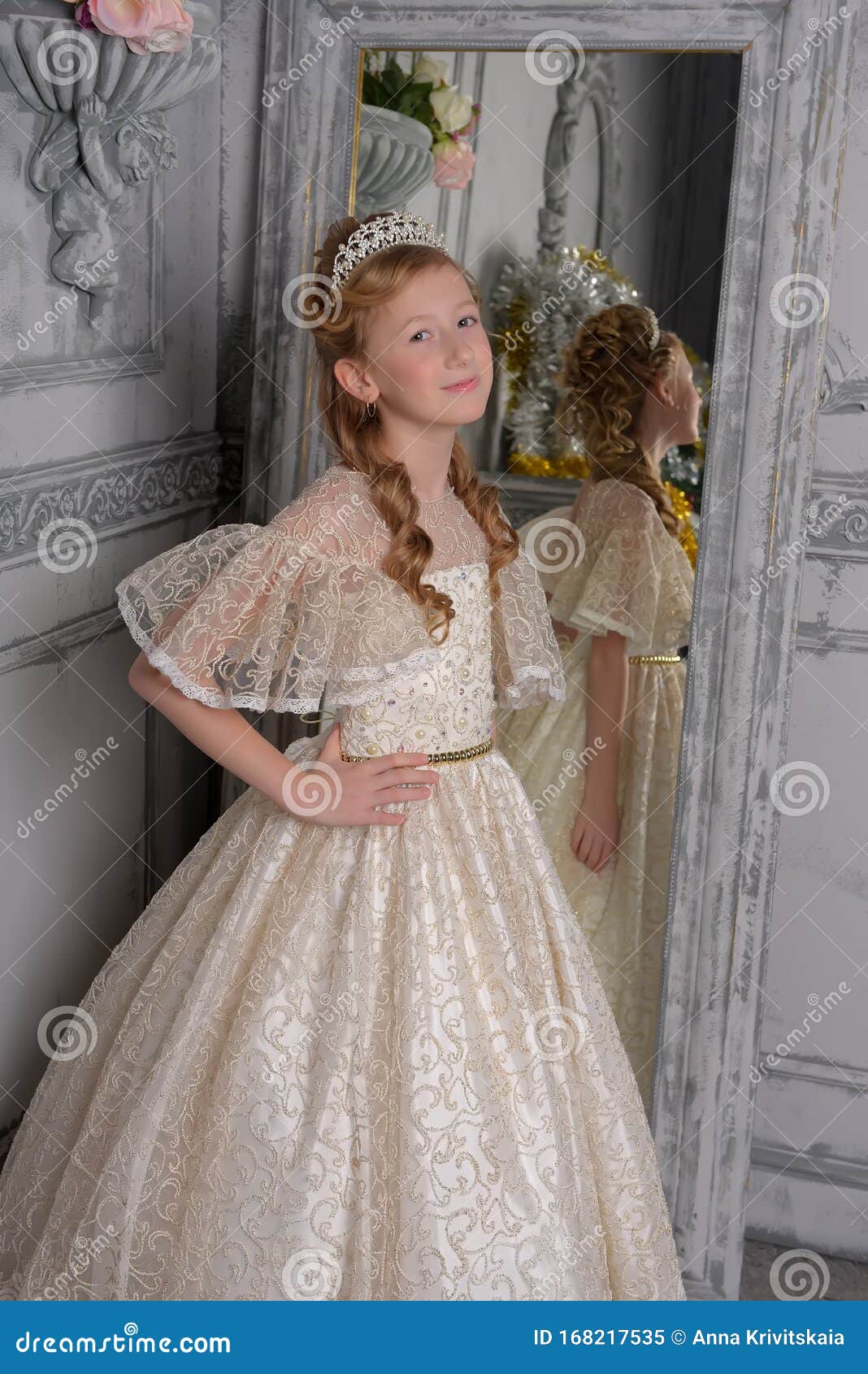 A Girl in a White Lace Dress with a Diadem in Her Hair, a Young Aristocrat,  a Ball Gown, Trying on a Dress in Front of a Mirror Stock Image - Image