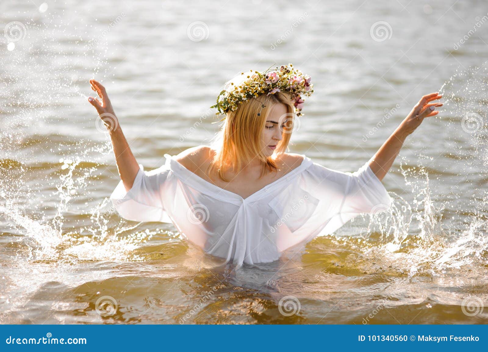 Girl in White Shirt and Floral Wreath Standing in Water Stock Photo ...
