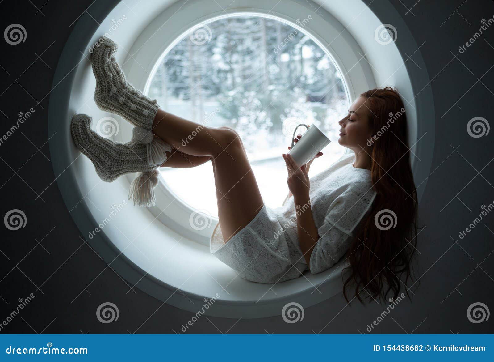 girl in white sport wear alies on window