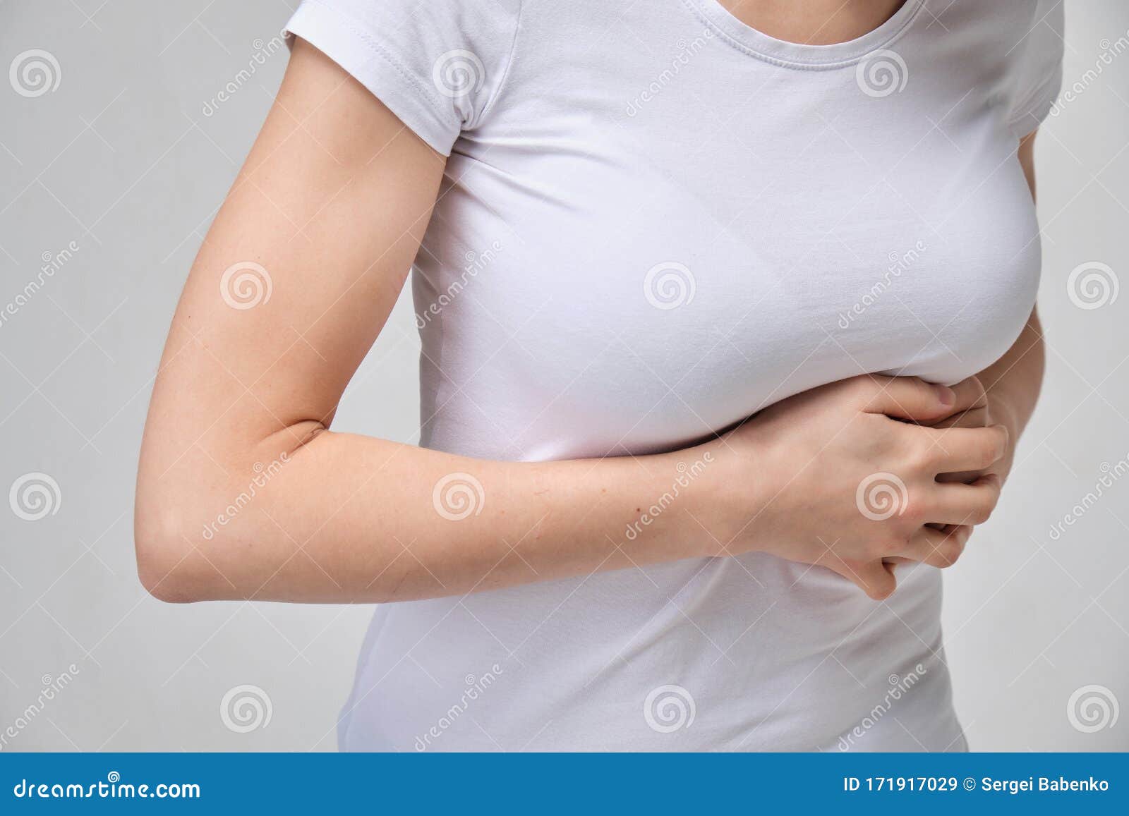 A Girl in a White T-shirt is Massaging Under Her Breasts. the Concept of  Intercostal Neuralgia Stock Image - Image of tshirt, background: 171917029