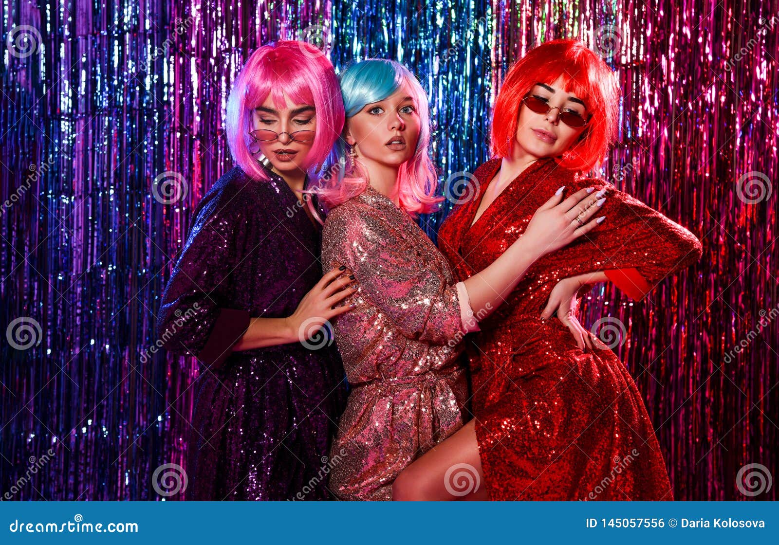 Girl in Wigs and Stylish Glamorous Dresses with Sequins, in the Neon ...