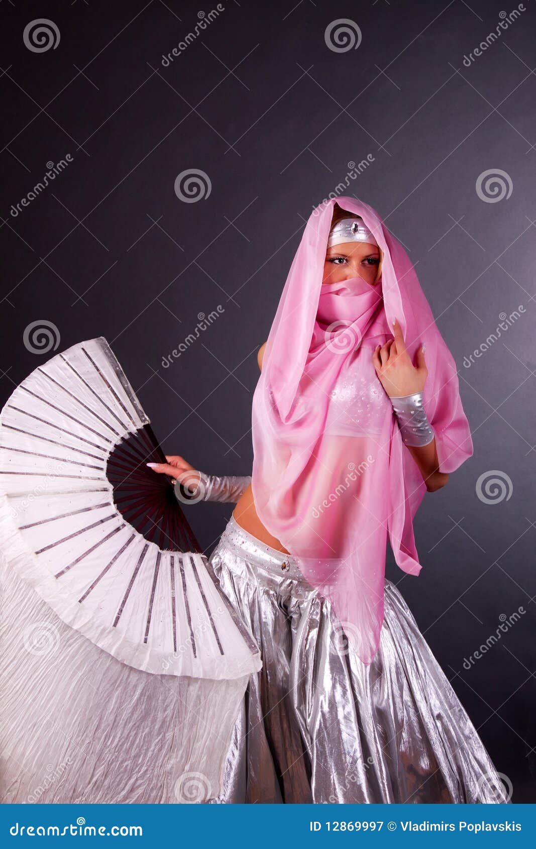 girl in yashmak holding a fan