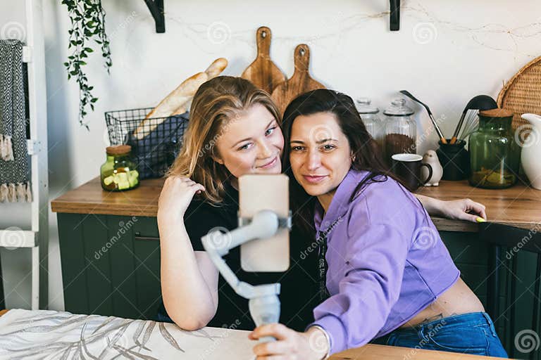 Girlfriends Laugh Merrily And Take Selfies In The Kitchen Stock Image
