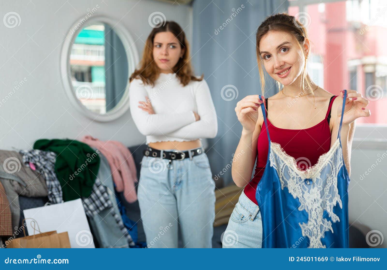 Girlfriends Reviewing Clothes at Home after Shopping Stock Image ...