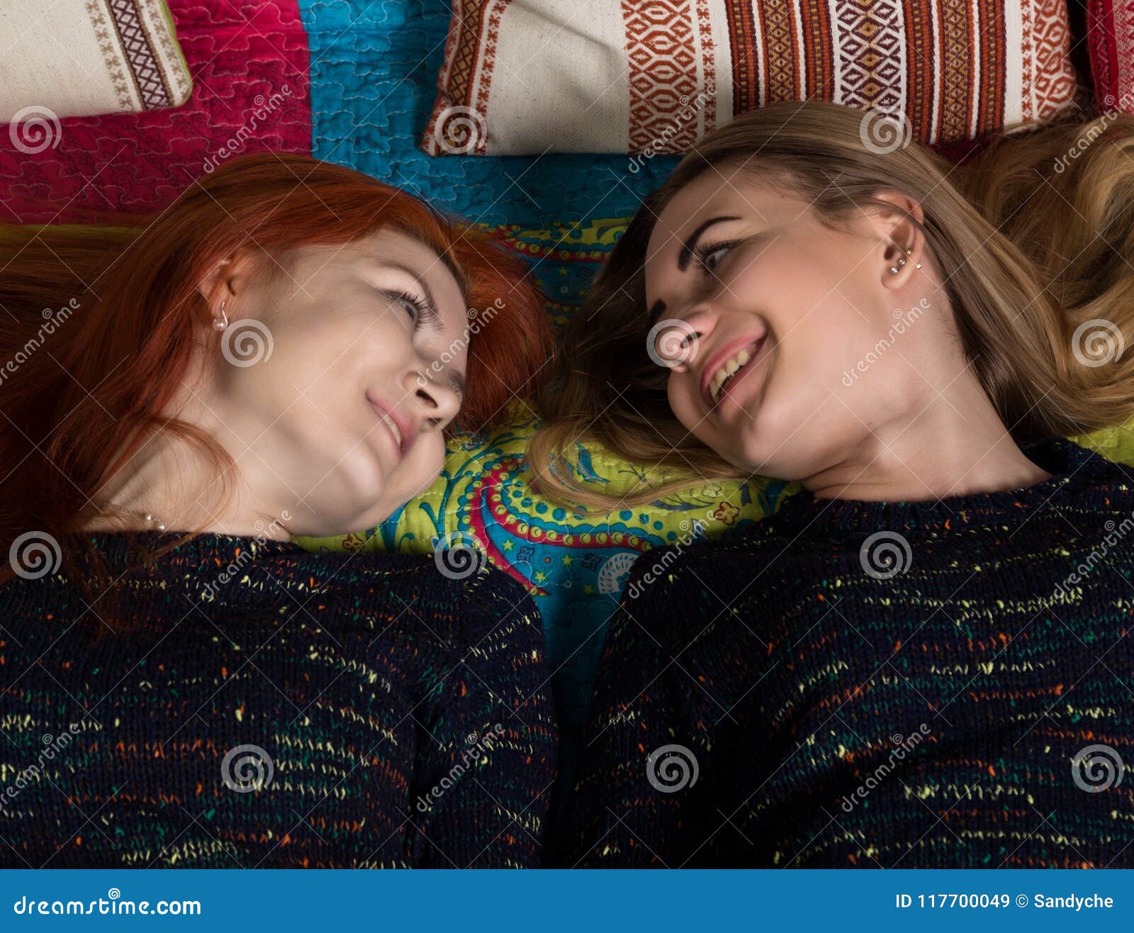 Two Pretty Lesbians Girlfriends Kissing And Hugging In A Cozy