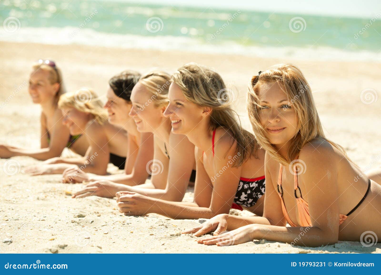 Girls in Bikini Lying on Beach Stock Image