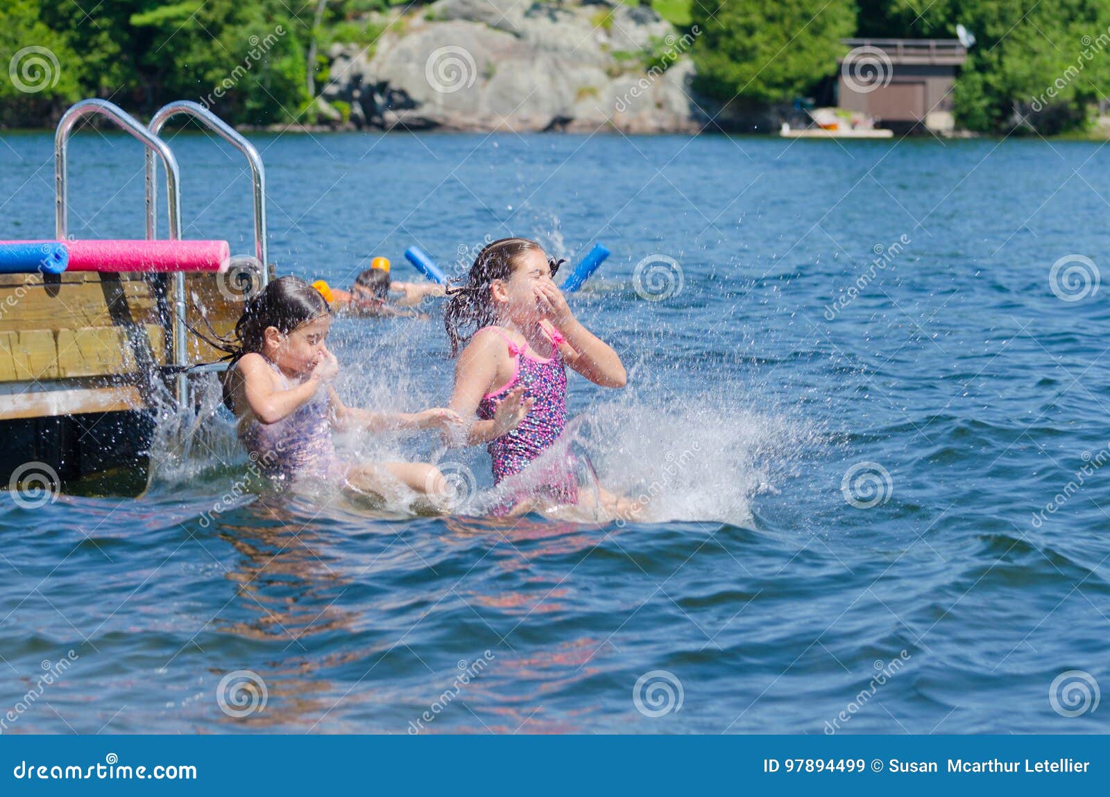 girls dive bombing friend off dock into lake