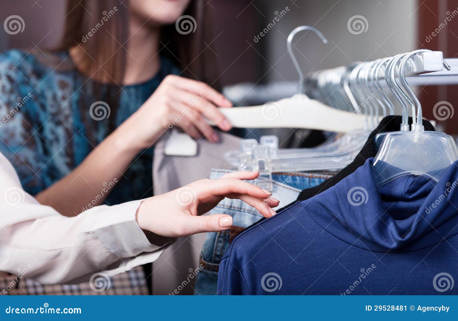 Girls finger the clothes stock image. Image of decide - 29528481