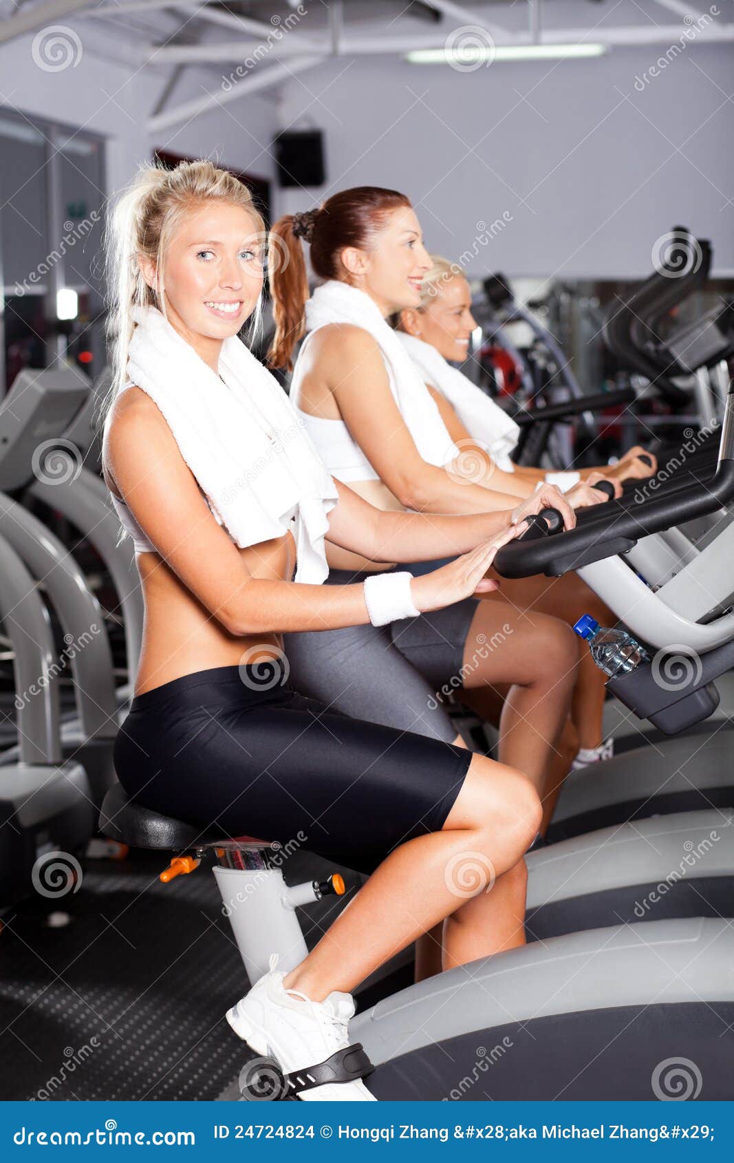 Girls on gym bike stock photo. Image of indoors, girls 24724824