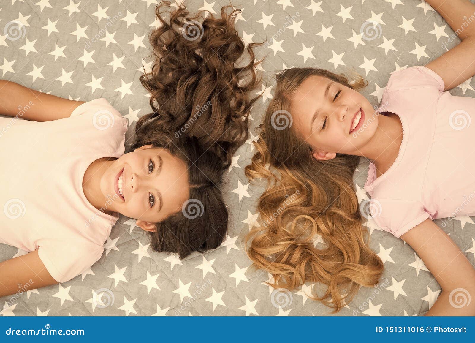 Girls With Long Curly Hair Lay On Bed Top View Children