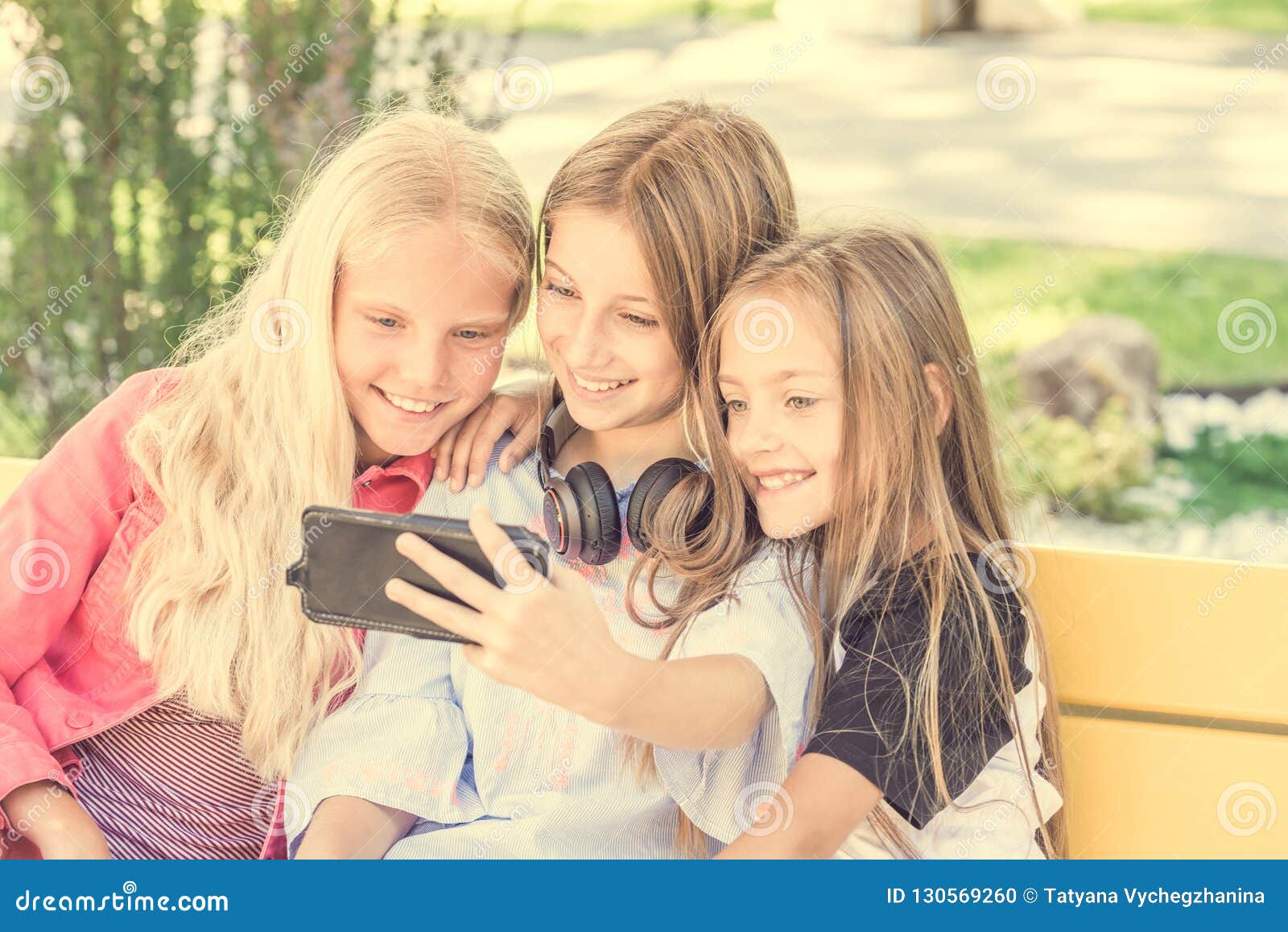 Girls Making Selfie Outdoors while Sitting on Longboards Stock Photo ...