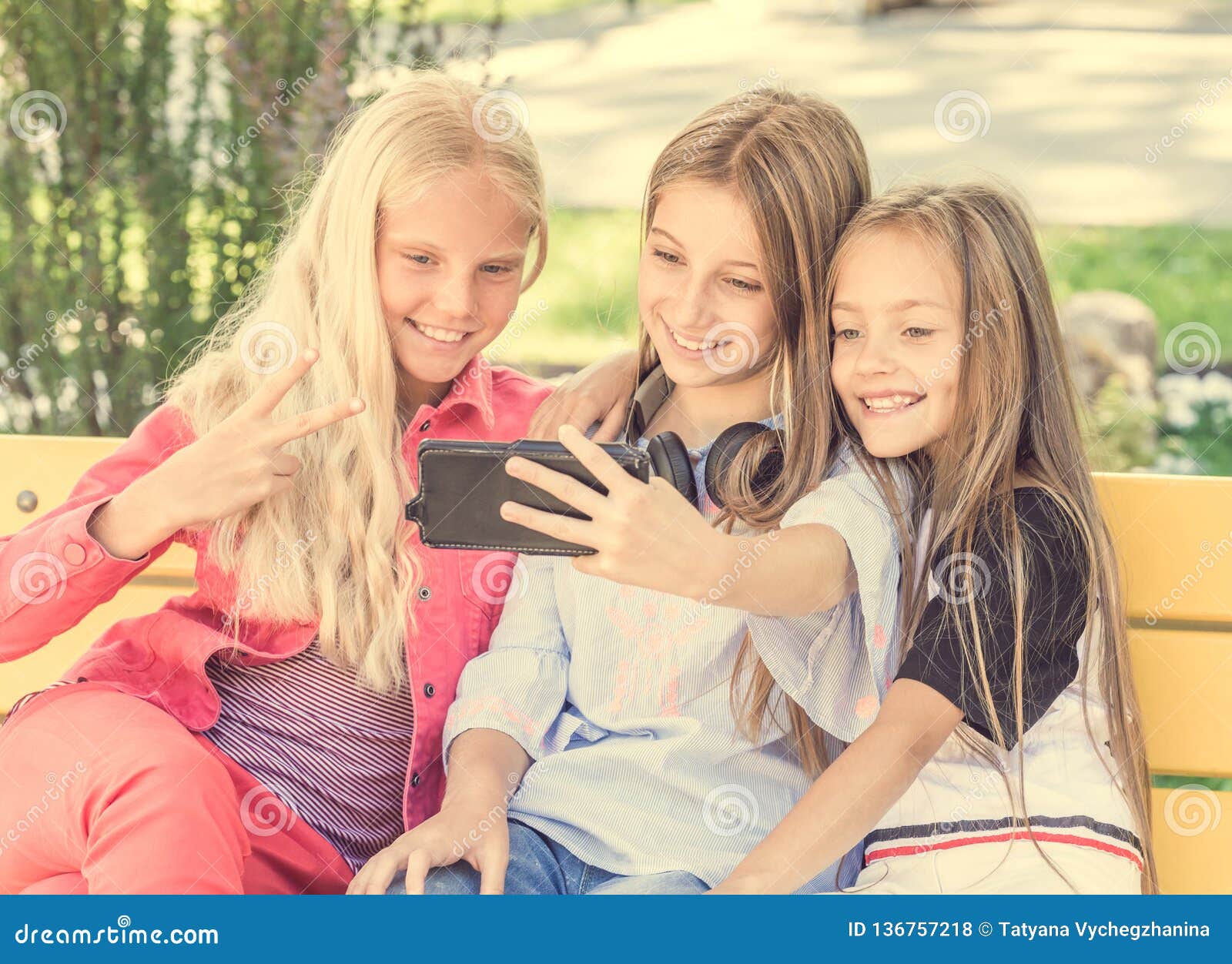 Girls Making Selfie Outdoors while Sitting on Longboards Stock Photo ...