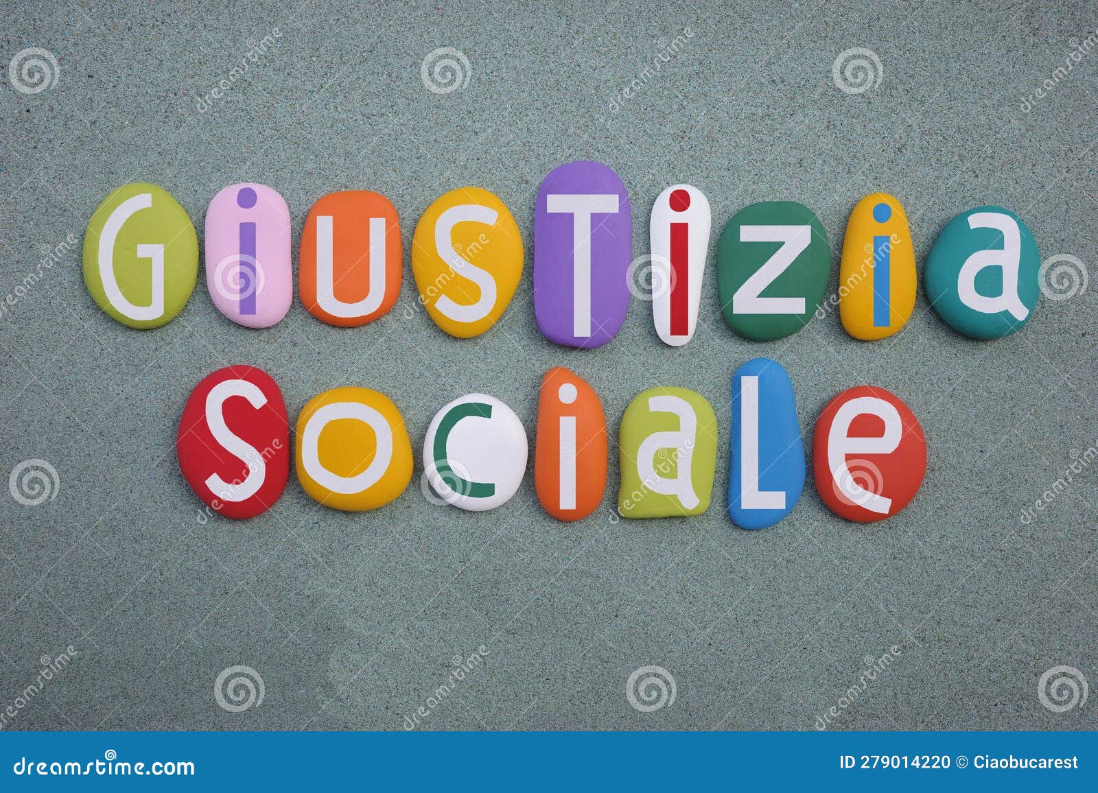 giustizia sociale, social justice in italian language composed with multi colored stone letters over green sand
