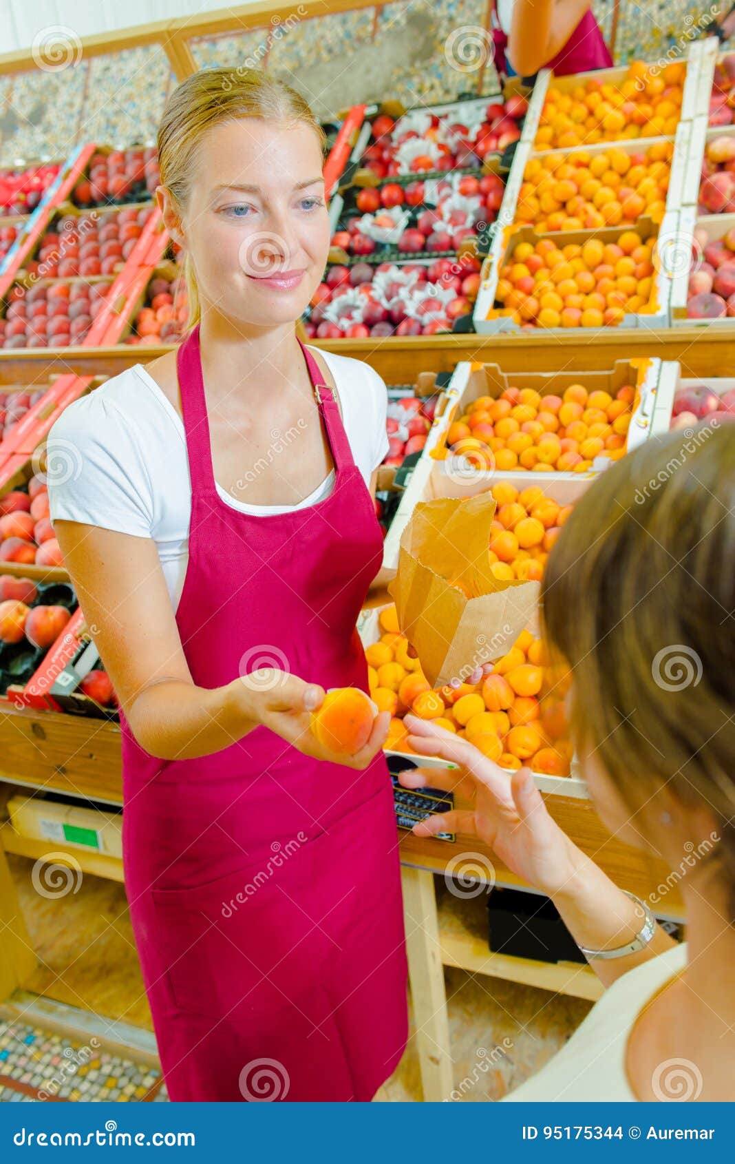 Giving orange to customer stock photo. Image of service 95175344