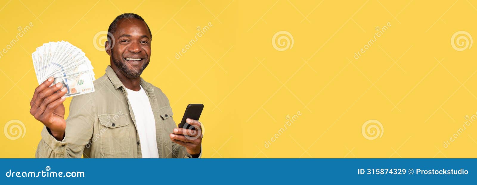 glad mature black guy showing many dollars cash, using smartphone