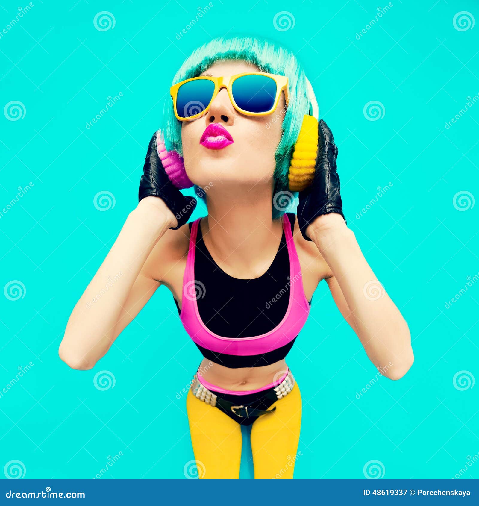 glamorous fashion dj girl in bright clothes on a blue background