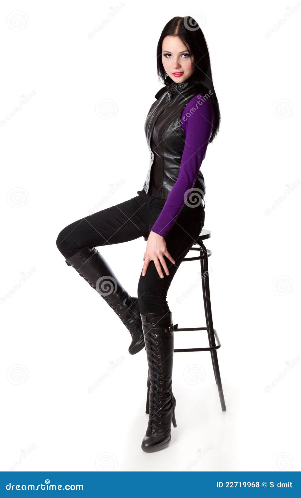 glamourous woman is sitting on a chair