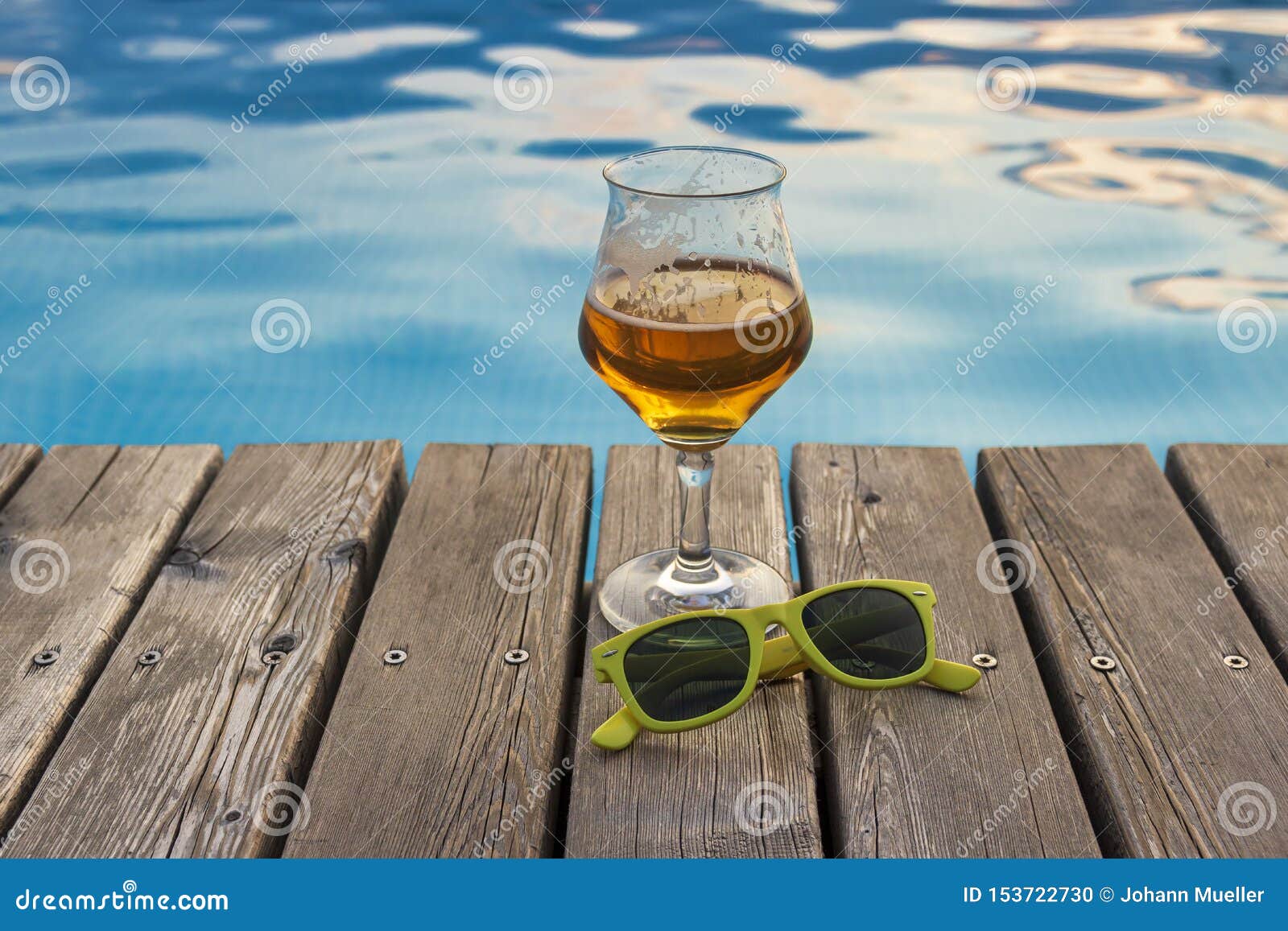 Glas of beer near pool. stock photo. Image of glass 153722730