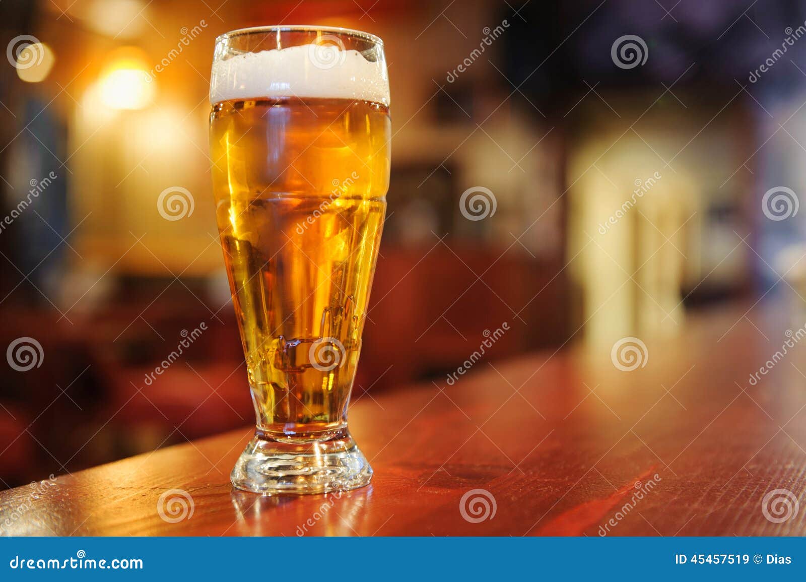 Glass of beer on the bar stock image. Image of beer, gold 45457519