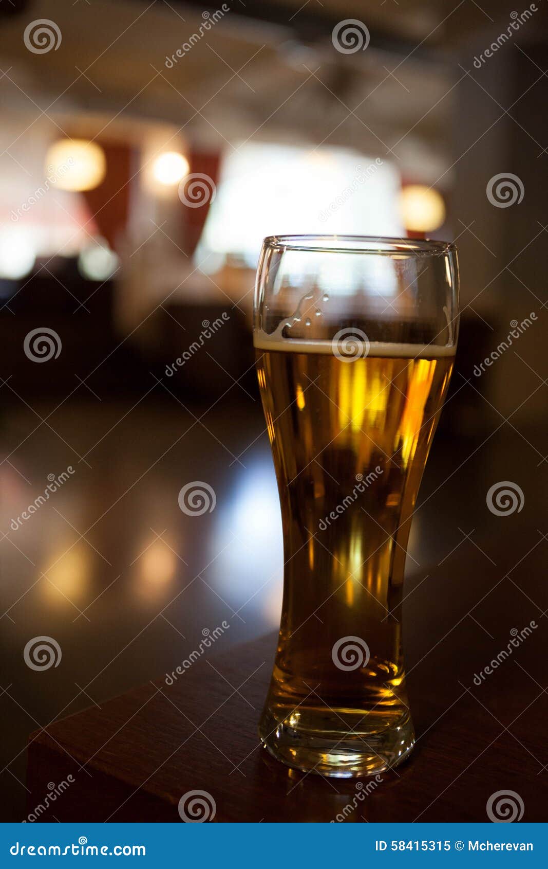 A glass of beer on the corner table in the restaurant.