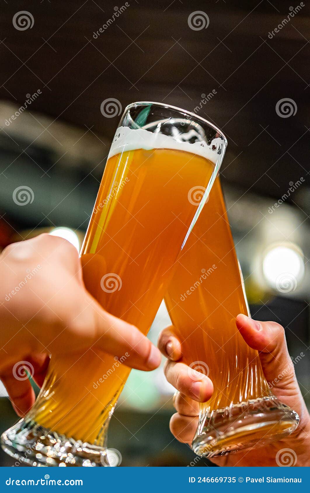 Glass of Beer in Man Hand. Beer Glasses Clinking in Bar or Pub Stock