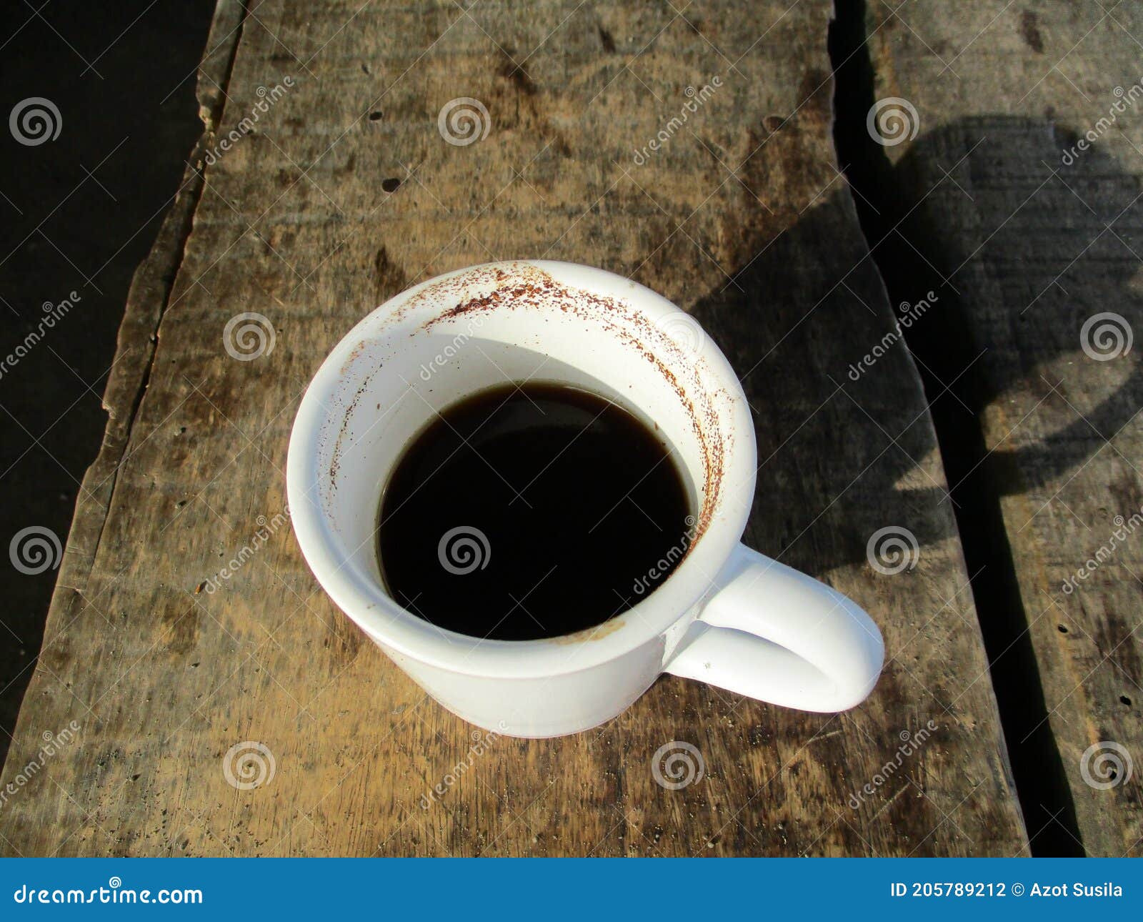 a glass of black coffee while relaxing outside the house