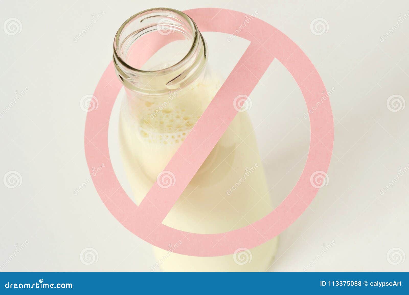 glass bottle of milk with restriction sign - lactose intolerance
