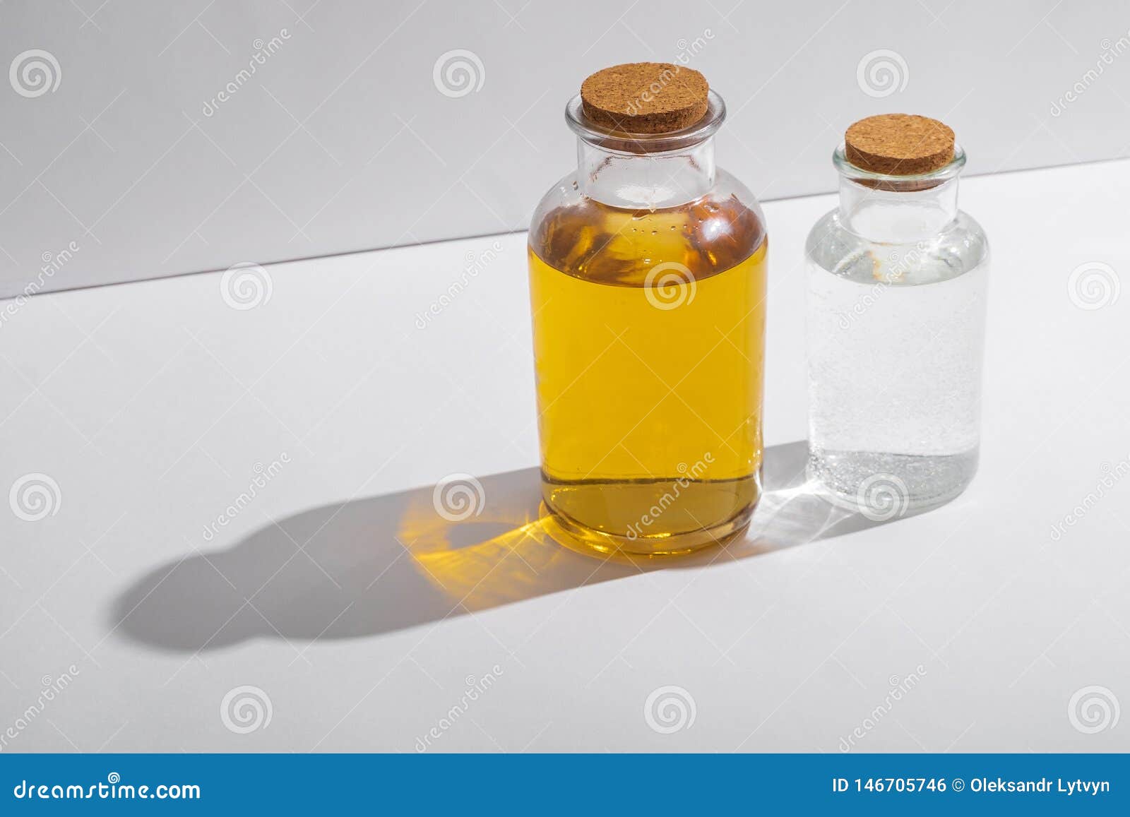 Glass Bottles with Cork Lids on a White Background, Side View Stock