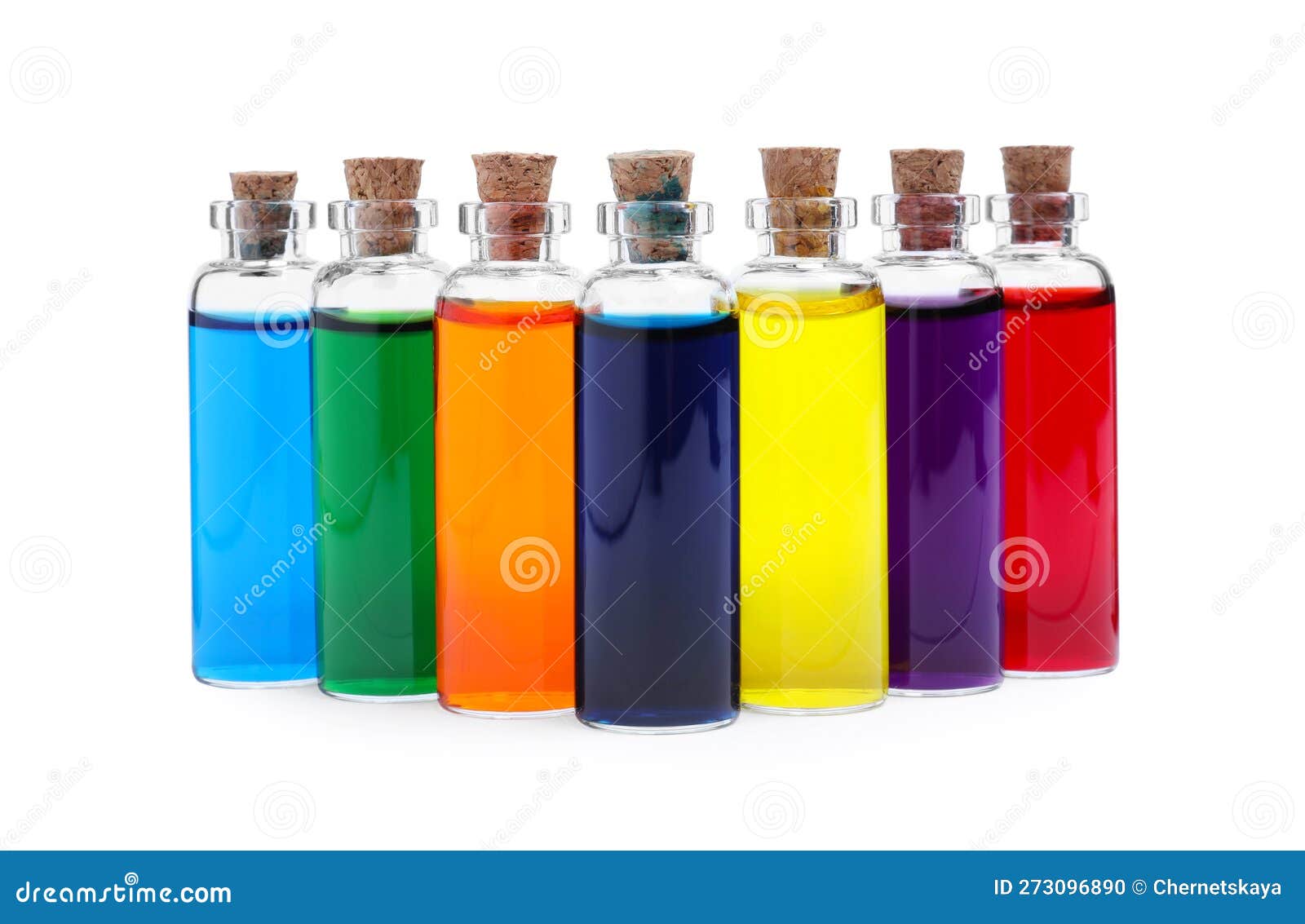 Glass Bottles with Different Food Coloring on White Background Stock